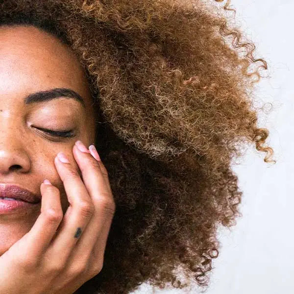 Woman with hands on her face