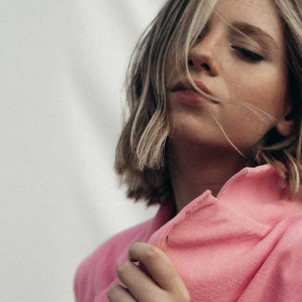 Woman posing with hair blowing in her face