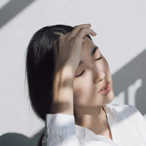 Woman shielding herself from the sun