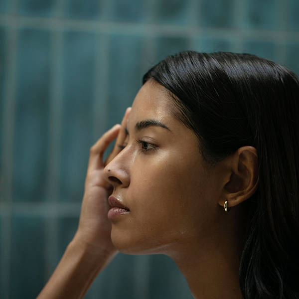 Woman touching her hand to her face